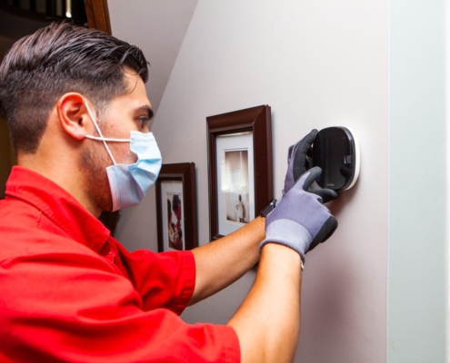 Technician Setting Thermostat