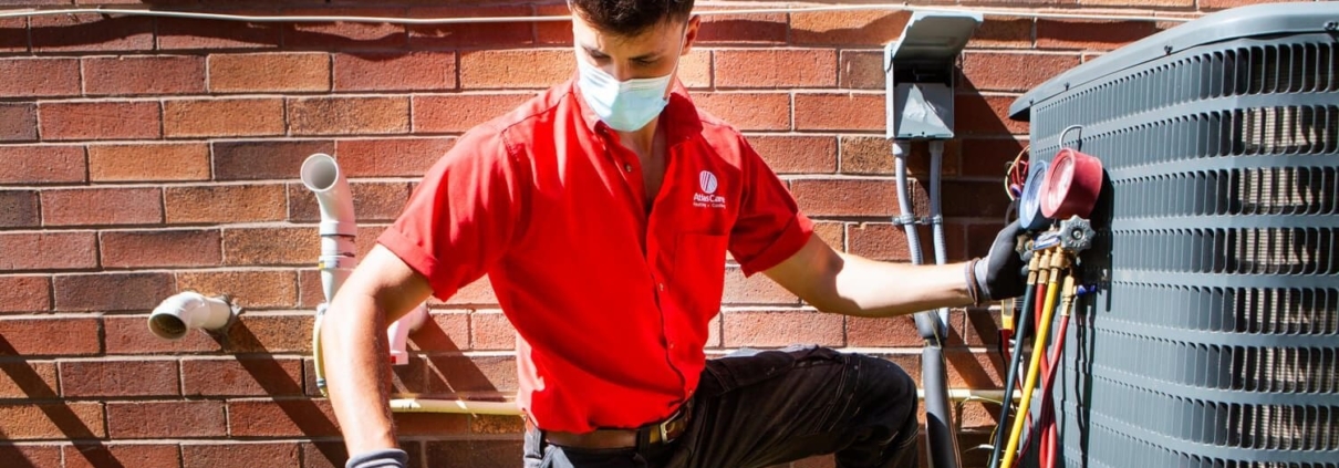 AtlasCare technician working on outdoor air conditioner unit