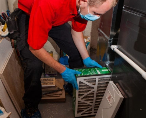HVAC technician removing a dirty air filter