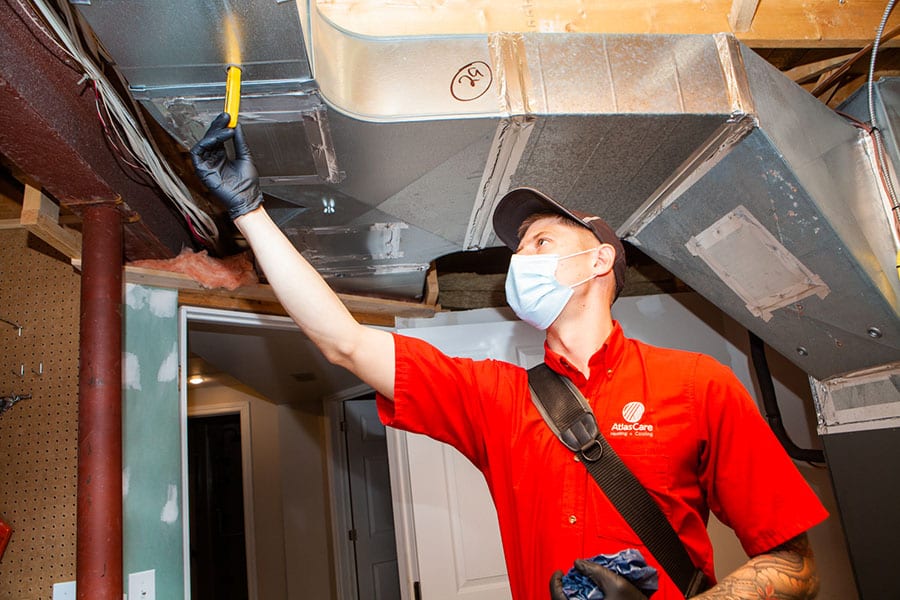 Technician installing a furnace in Oakville ON